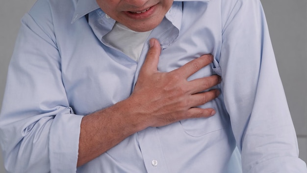 Asian man has chest pain caused by heart disease