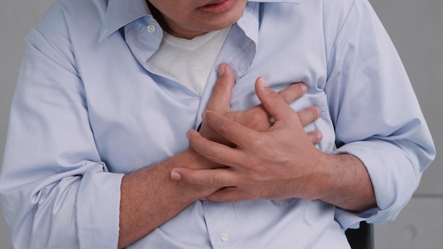 Photo asian man has chest pain caused by heart disease