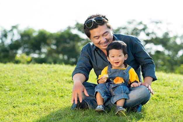 Asian man and his little son