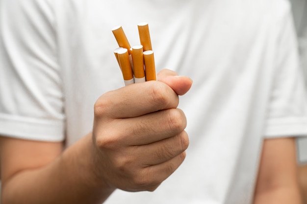 Asian man holding cigarette in hand no smoking