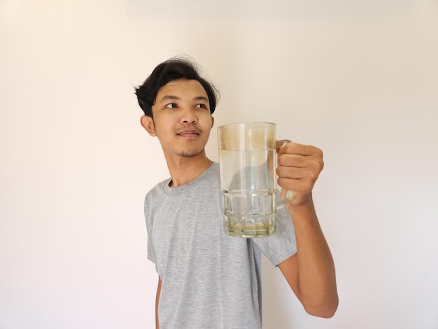 Asian man is drinking a glass of water and happy