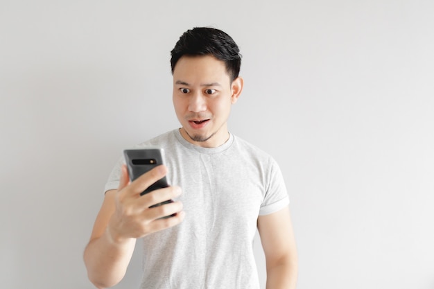 Asian man is feeling happy with the application in the smartphone.