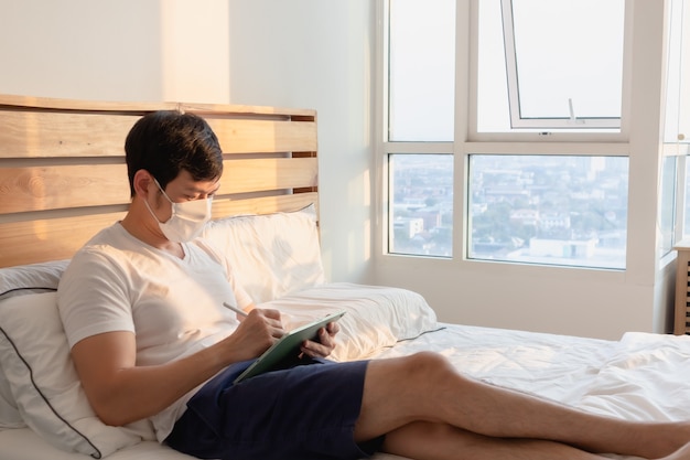 Photo asian man is in an online meeting in concept of work from home.