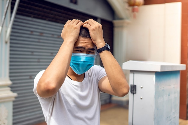 Asian man is wearing surgical mask