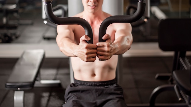 Asian man is working out  in fitness gym 