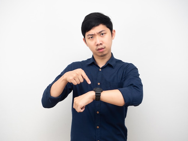 Asian man point finger at his watch looking at you serious emotion hurry concept