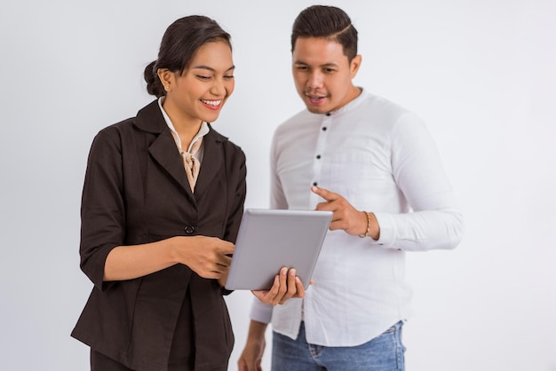 Asian man pointed his finger while looking at the digital tablet