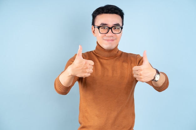 Asian man posing on blue background