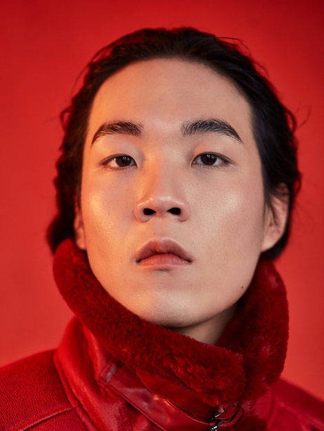 Asian man in red clothes on a red space