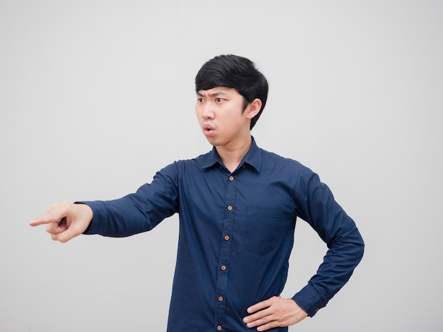 Asian man serious face point finger command emotion on white background