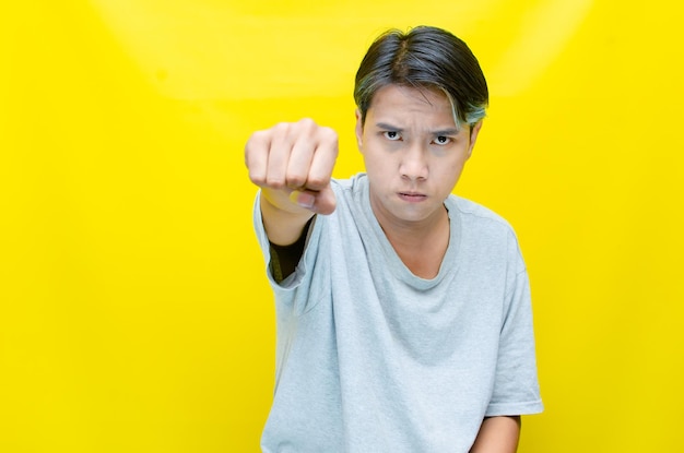 Asian man shouting and pointing his finger in anger