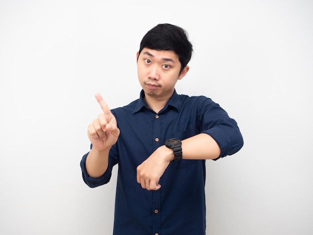 Asian man show his watch and swing his finger looking at you time late concept