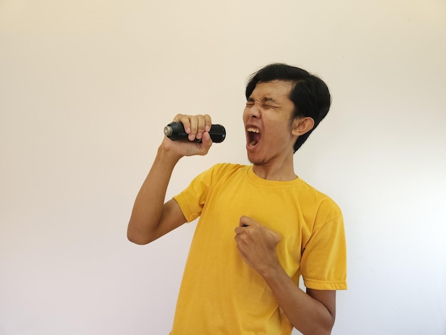 Asian man singing a song with a microphone happy and relax enjoy the moment