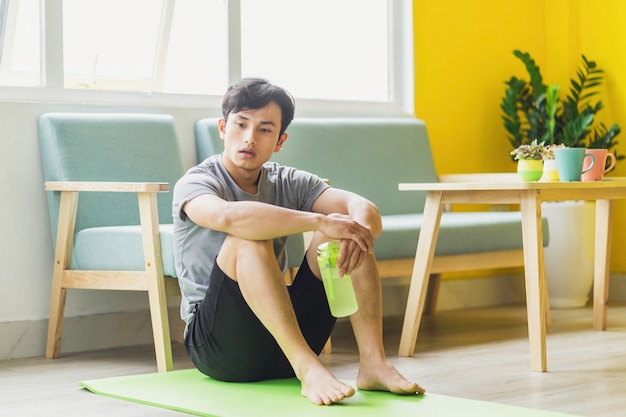 Asian man sitting at rest after exercise