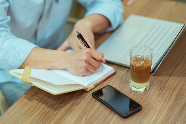 Asian man sitting working alone at a coffee shop