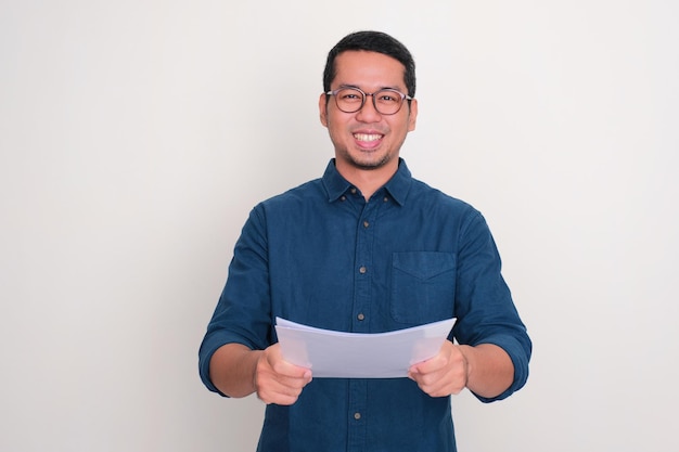 Asian man smiling happy while giving a doucment folder