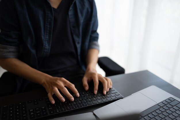 asian man software engineer working on computer at office desk for writing program code it software engineer finding errors tech support devops creating digital