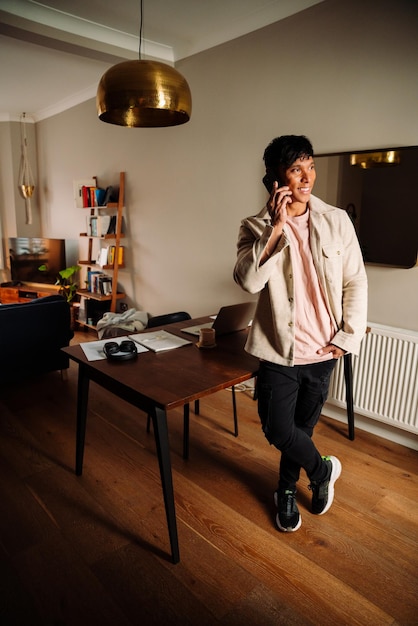 Asian man standing at desk chatting