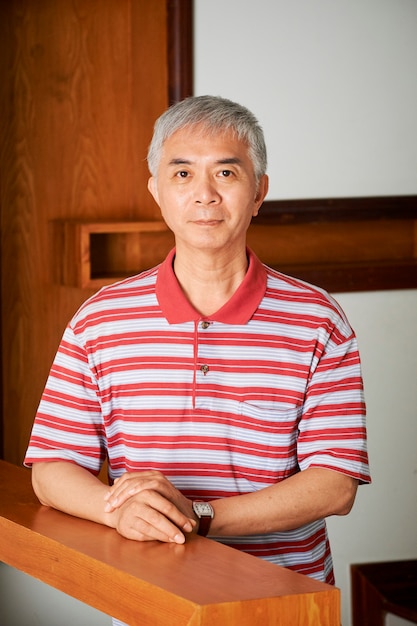 Asian man standing in his house