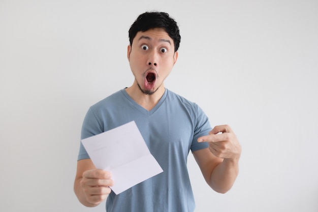 Asian man surprise and shocked by the letter in his hand