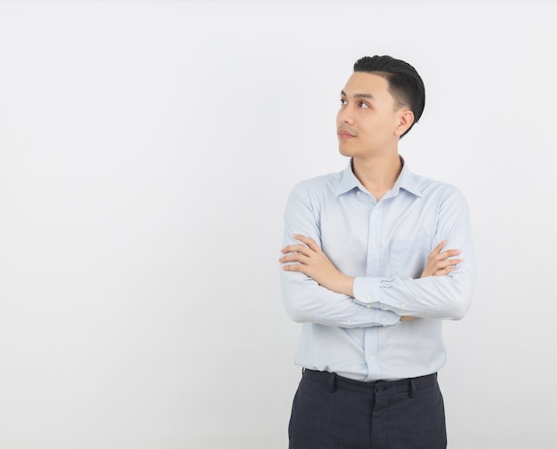 asian man thinking an idea while looking up with arms crossed isolated on white background