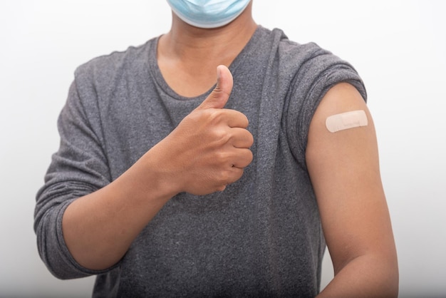 Asian man thump up and Confident after being vaccinated