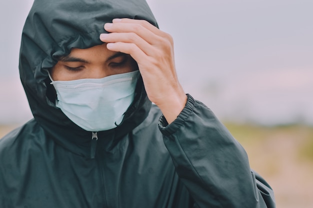 Asian man use surgical mask or face mask to protect corona virus 2019 or covid 19 in public