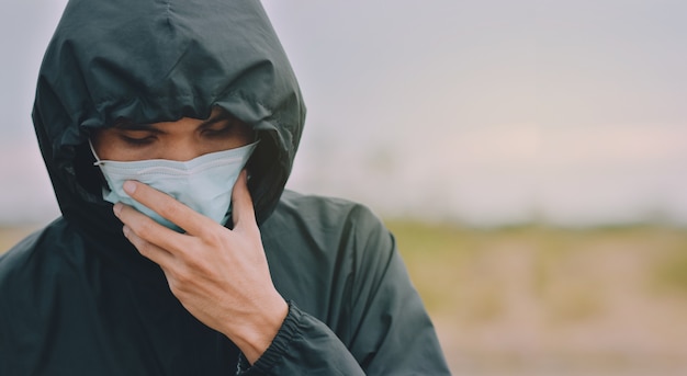 Asian man use surgical mask or face mask to protect corona virus 2019 or covid 19 in public