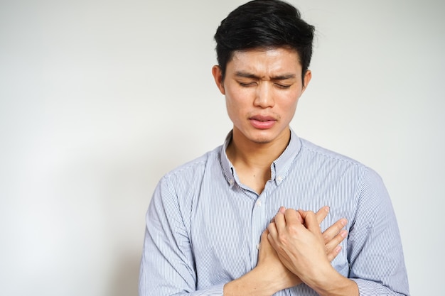 Photo asian man using hands massage on chest after feeling pain , heart attack