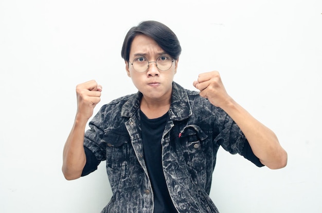 Asian man wearing black over isolated background angry, mad, frustrated and furious