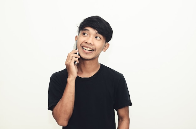 An Asian man wearing a casual black shirt is on the phone