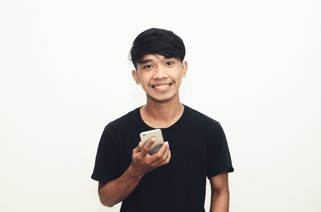 An Asian man wearing a casual black shirt is on the phone