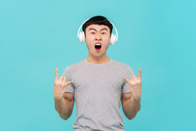 Asian man wearing headphone listening to music