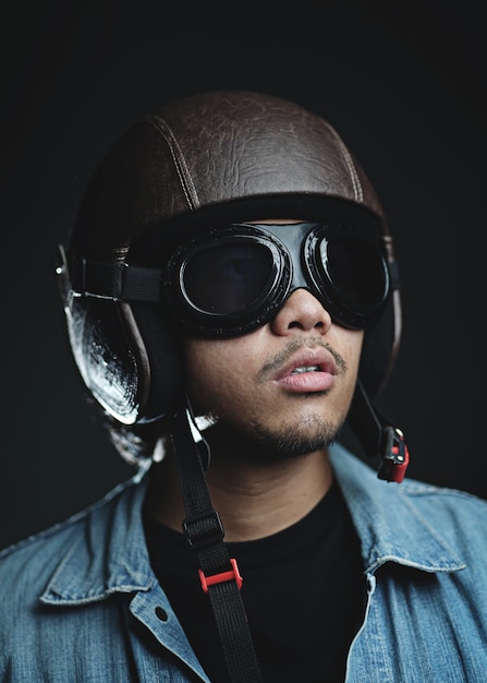 Asian man wearing retro helmet and goggles