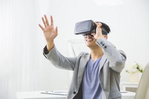 Asian man wearing virtual reality goggle