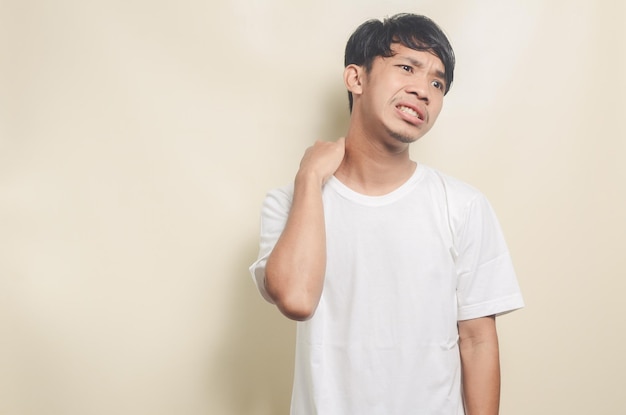 Asian man wearing white tshirt backache isolated background