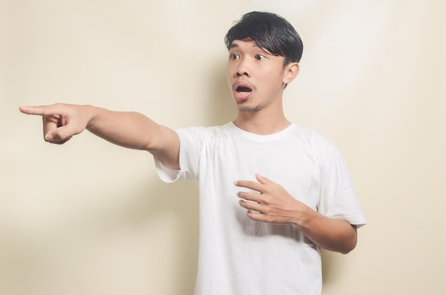 Asian man wearing white tshirt with pointing forward gesture on isolated background