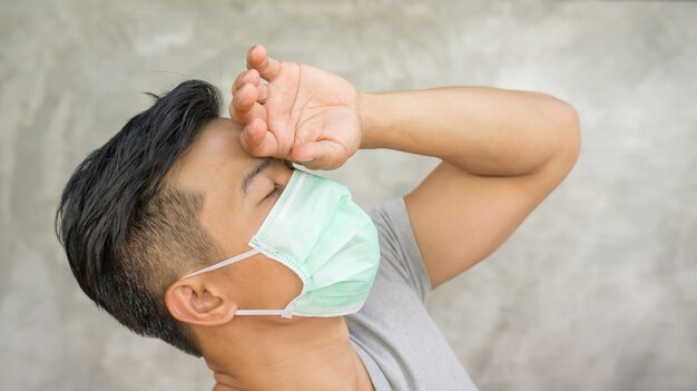 Asian man wears a protective mask.