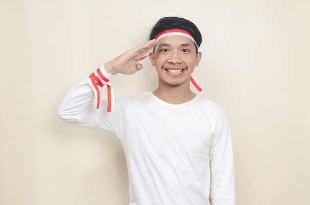 Asian man in white shirt wearing red and white ribbon on his head celebrating independence