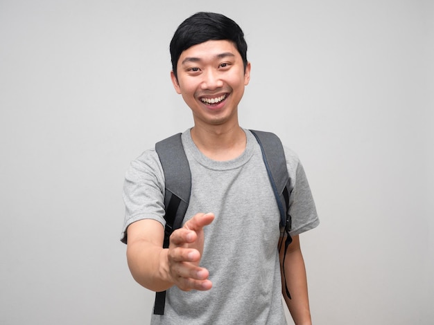 Asian man with bag happy smile gesture shake hand to you