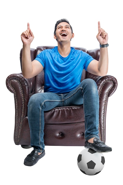 Asian man with the ball sitting on the couch with an excited expression