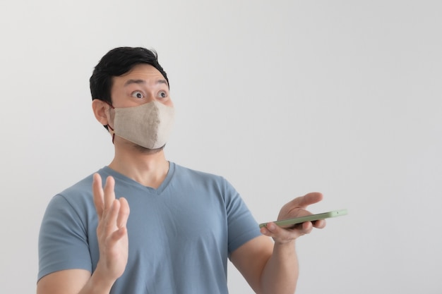 Asian man with mask is happy with the promotion in the smartphone application