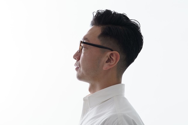 Asian man with a serious face wearing glasses