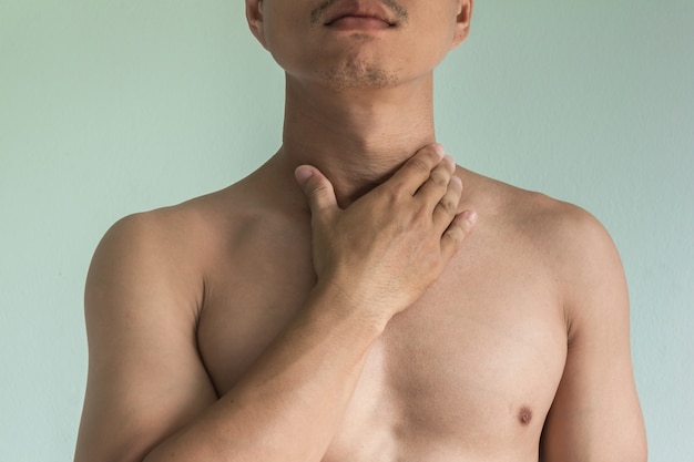 Asian man with sore throat