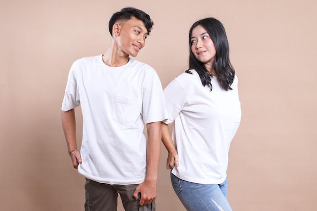 Photo asian man and woman couple wearing white tshirt for mockup on beige background