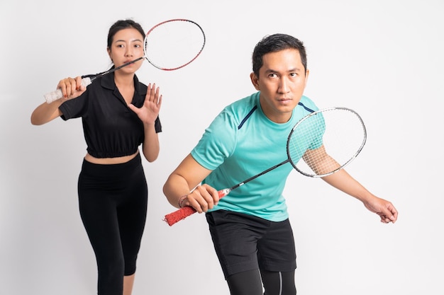 Asian man and woman standing ready to hold racket on isolated background