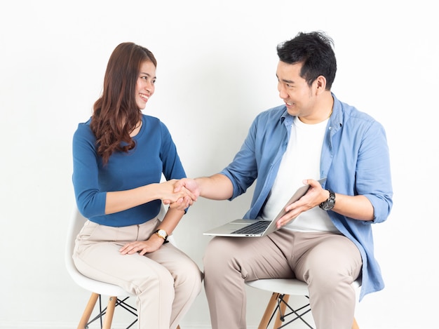 Asian Man and Woman talking with laptop computer for business on white background