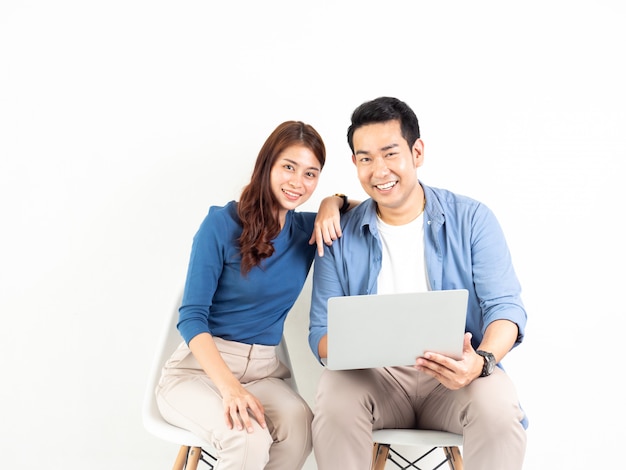 Asian Man and Woman talking with laptop computer for business on white background