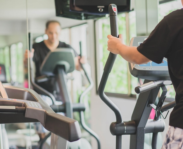 Asian man work out exercise at Gym weight loss