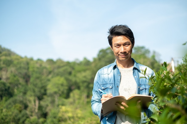 Asian man working in green tea plantation in Chiang-Mai THAILAND,